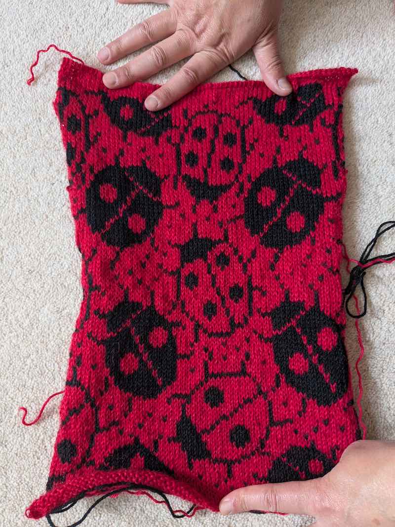 A knitted fabric with ladybirds on